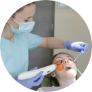 Photo of a dental hygienist working on a patient's teeth